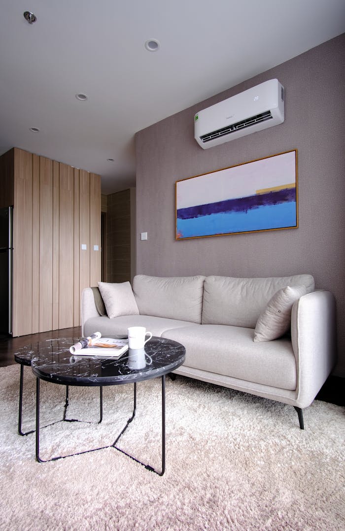 Bright and stylish living room interior featuring a comfy beige sofa and a sleek coffee table.